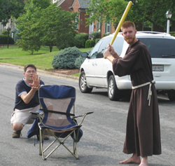 Brother Richard Goodin, O.F.M. joins a game of Wiffle ball.